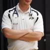 An unidentified man with arms crossed sports Buff gear and a stethoscope.
