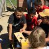 CU Boulder astronomy and physics student Sam Strabala searches for sunspots with middle schoolers in Keenesburg, Colorado as part of a science outreach program.