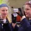 Researchers holding lab samples
