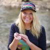 Graduate student Julie Byle holds an aquatic invertebrate near creek