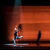 Dancers on stage in orange light