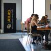 Students studying, on laptops in ATLAS Center lobby