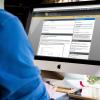 Man working in Desire2Learn program on Mac computer