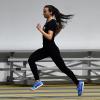 Dani Jones runs past empty bleachers