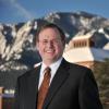 Dean David Ikenberry stands in front of the Leeds School of Business