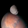 A striking view of Mars and its smallest moon, Deimos.
