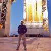 Sreyas Krishnan in front of the Delta IV Parker Solar Probe in Cape Canaveral
