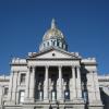 The tower of the state capitol building in Denver, Colorado, appears against a clear blue sky.