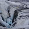 A person stands atop ice. 