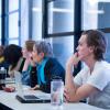 Campus community members listen to a speaker in UMC 247