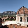 Tops of campus buildings with Flatirons in the background