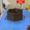 3D printing tip places layers of brown paste