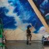 A mural being painted at CU Boulder's new aerospace building