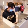 Joshua Vierra, a sophomore music cello performance major  casts his ballot at a poling place in the UMC at the University of Colorado Boulder. (Photo by Casey A. Cass/University of Colorado)