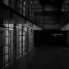 A black and white photo of prison cells