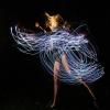 Emily Daub performs a modern dance while wearing LED-lit costume