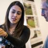 A student discusses a design drawing with a community member.
