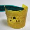 An "electronic skin" device bends in a curve.