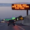 Highway road sign reads: "Extreme heat. Save power 4-9 p.m. Stay cool."