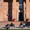 Students sitting on benches outside of Norlin Library