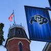 Old Main building and a CU flag