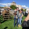 People taking part in a pre-game tailgate during Family Weekend with Ralphie in the background