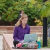 Student on laptop sitting outside on campus