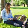 female studying outdoors on campus