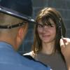 A police officer gives a volunteer a roadside sobriety test