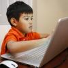 Child working on laptop computer