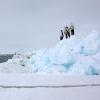 Community members from Utqiagvik, Alaska, look to open water from the edge of shorefast sea ice
