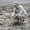U.S. Fish and Wildlife Service worker surveys grass