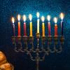 Menorah lit with purple, orange, red and yellow candles 