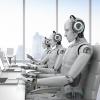 Robots working at laptops in corporate office