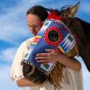 A member of the Lakota nation hugging a horse's head