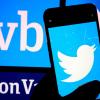 Person holding a phone with Twitter logo in front of a Silicon Valley Bank sign