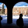 Silhouettes of students walking on campus on a snowy day