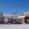 Building on campus on a snowy day with blue skies
