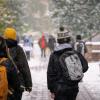 Students walking across a snowy campus