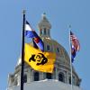 CU Boulder flag in front of Colorado capitol building.