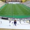 Students clean up Folsom Field after a game
