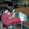 Woman in red track suit puts her feet up while working on a desktop computer