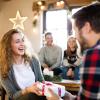 College age friends celebrating the holidays and exchanging gifts