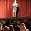 Stand up comedian on stage in front of an audience