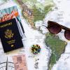 laydown of map, passport, sunglasses, travel brochure