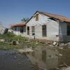 A house in Houston shows visible damage after flooding. 