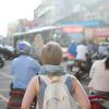 Woman wanders through busy street