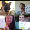Libraries staff pose for virtual photo with 'good luck' signs