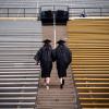 Graduates walking up steps at Folsom Field