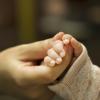 Mom holding her baby's hand